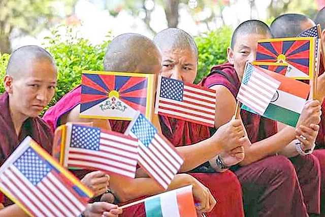 Tibetans greeting the US representatives. They are holding flags of US, India and Tibet. The picture was taken from Himachal province of India on 18 June.